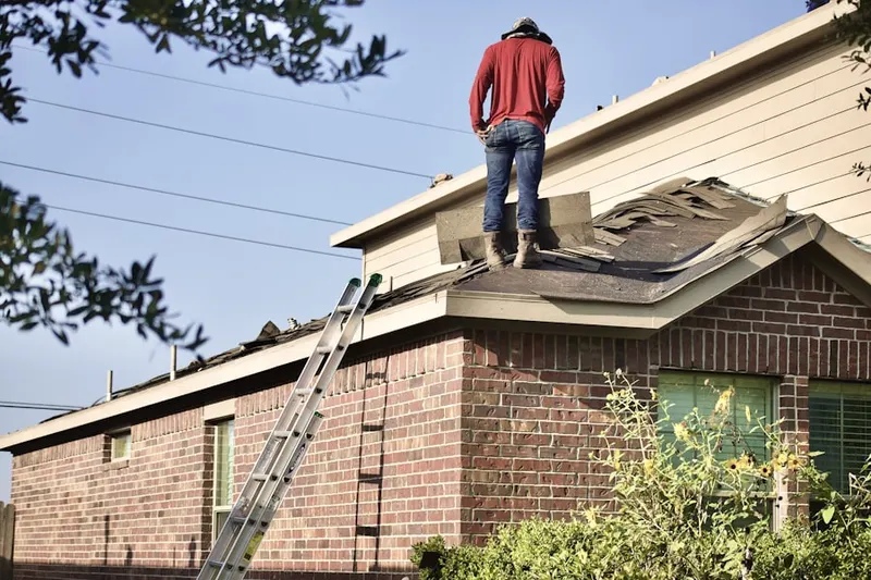 Professional roofer working on a residential roof in Fryville